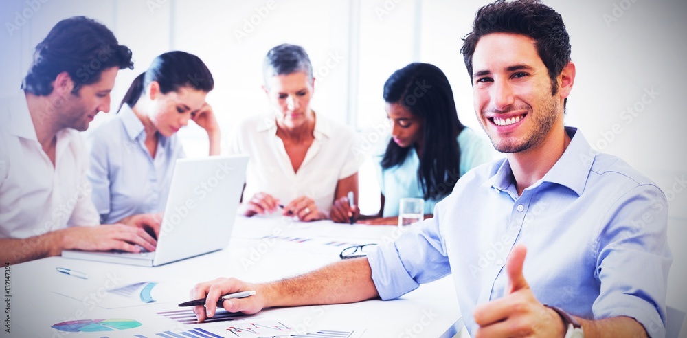 Attractive businessman smiling in the workplace