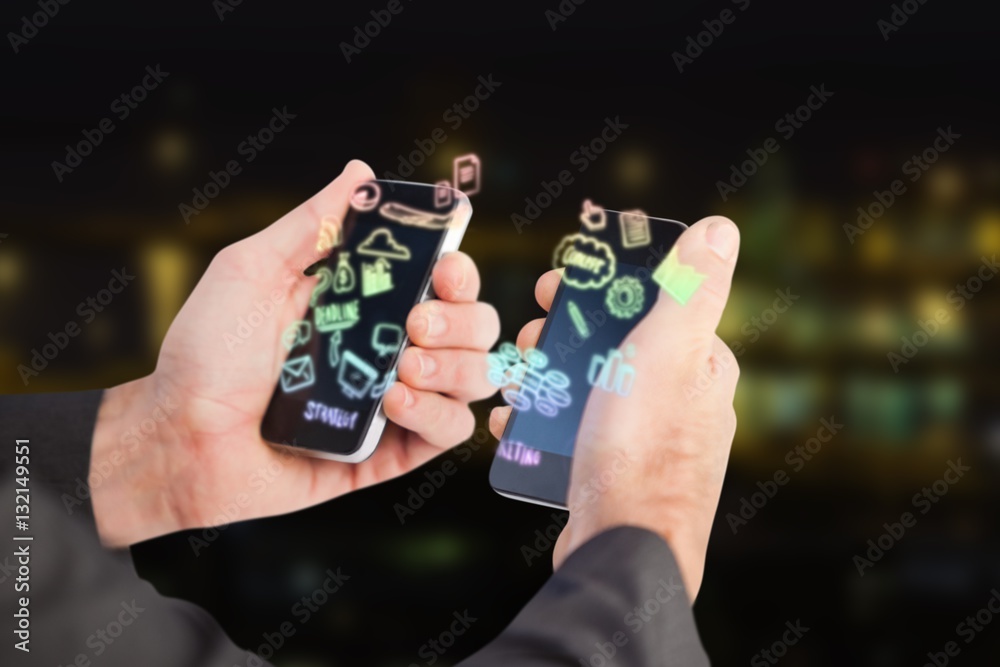 Composite image of businessman holding a phone in each hand 3d