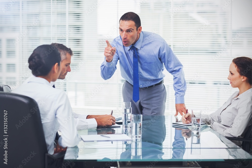 Angry executive pointing out his employee