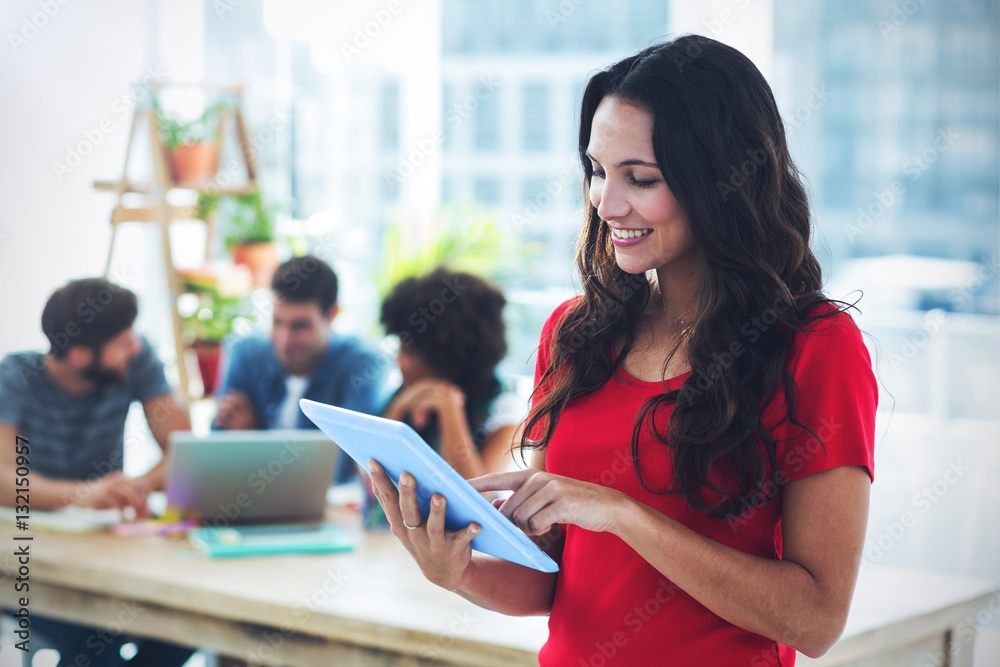 Smiling young businesswoman using tablet 