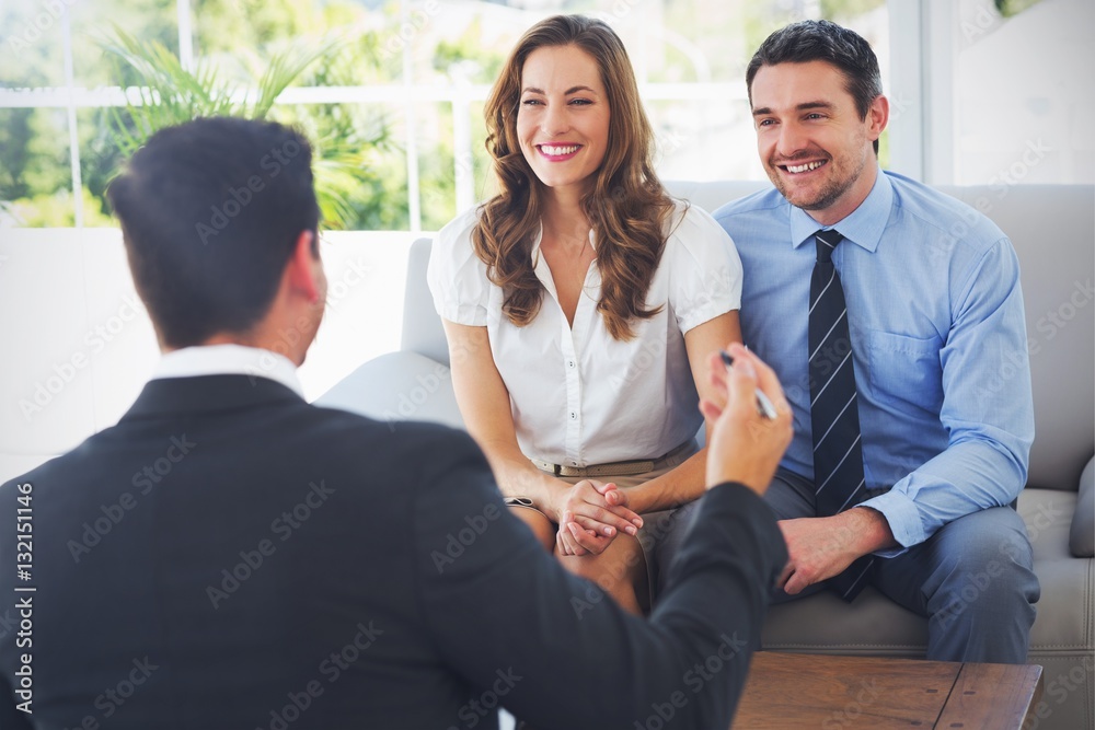 Smiling couple in meeting with a financial adviser