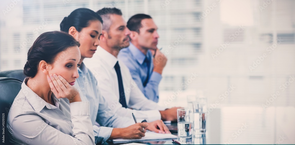 Businesswoman getting bored while attending presentation