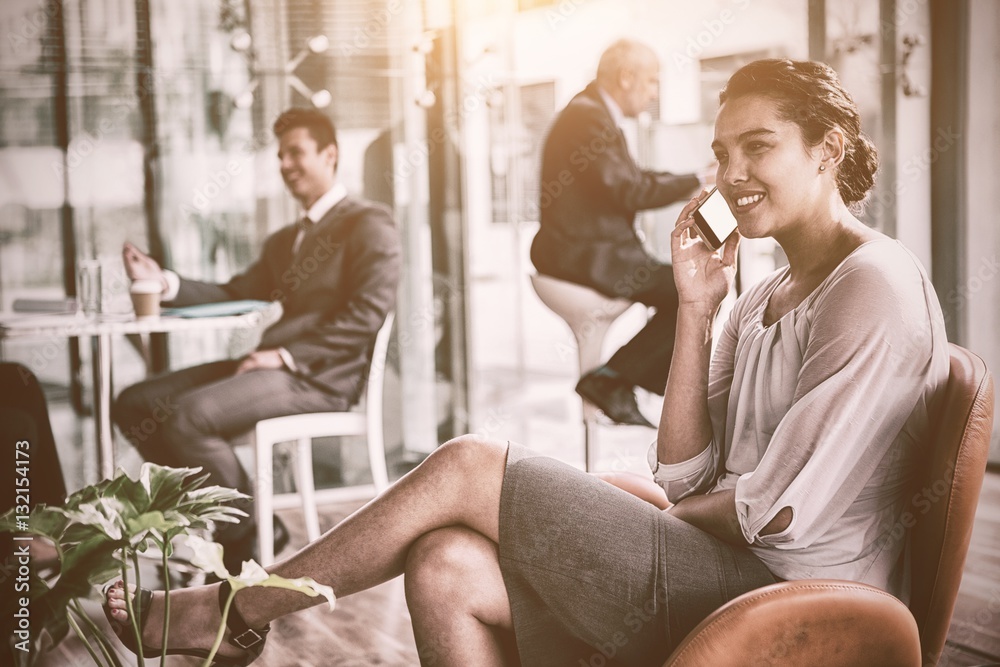 Happy businesswoman talking on phone