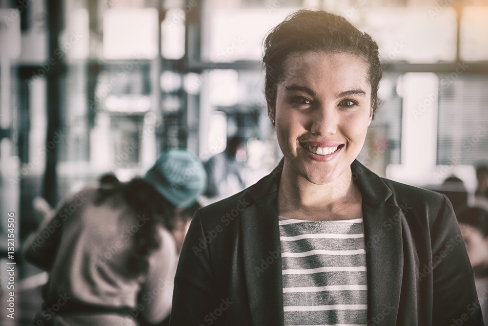 Smiling businesswoman standing in office