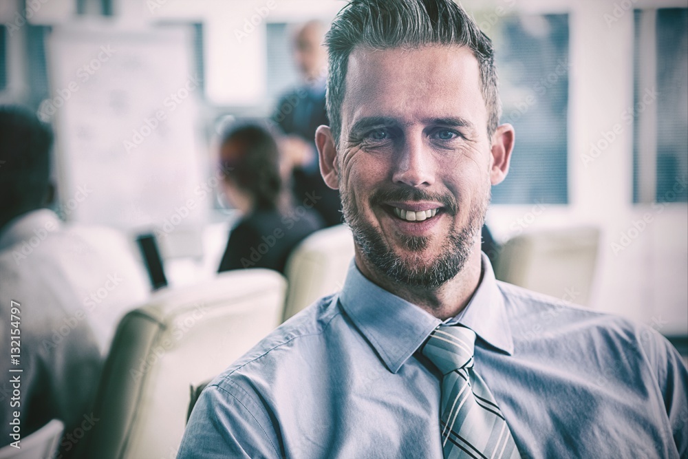 Smiling businessman sitting in office