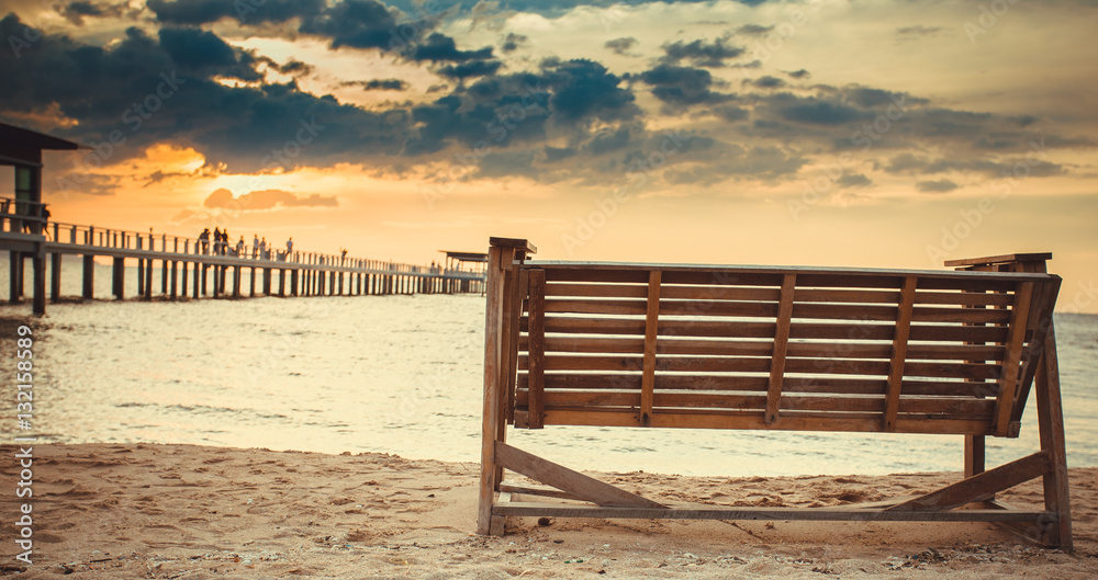 Rocking chairs on the Sand at beach front with blue sky Sunset