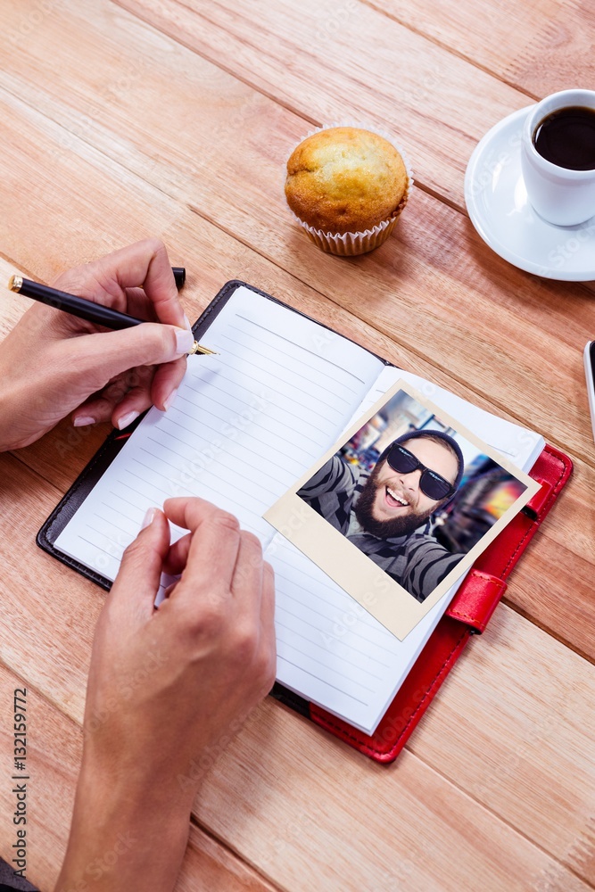 Composite image of happy hipster against wooden fence