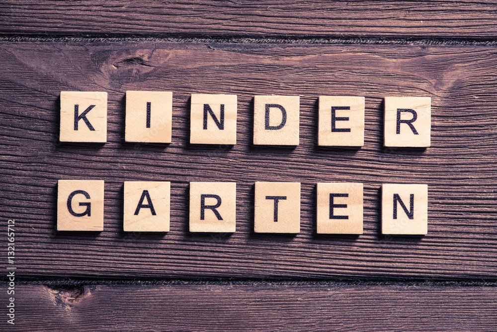 wooden elements with letter collected to word kinder garten