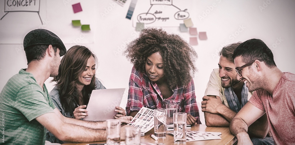 Creative team going over contact sheets in meeting