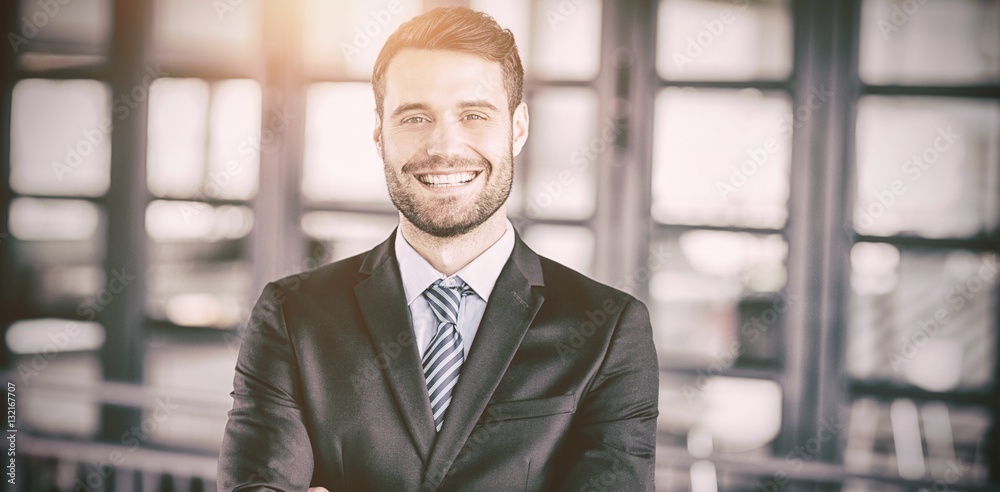 Happy businessman with arms crossed