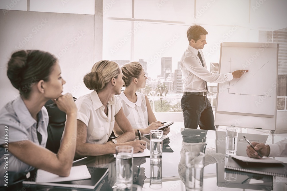 Businessman pointing at a growing chart