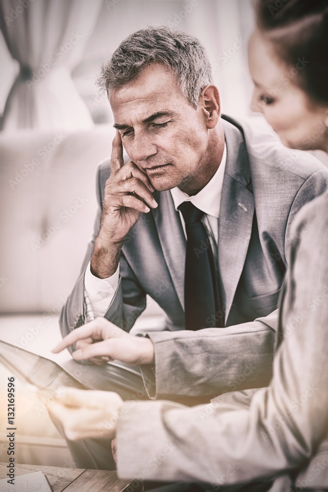 Smiling businessman working with his colleague