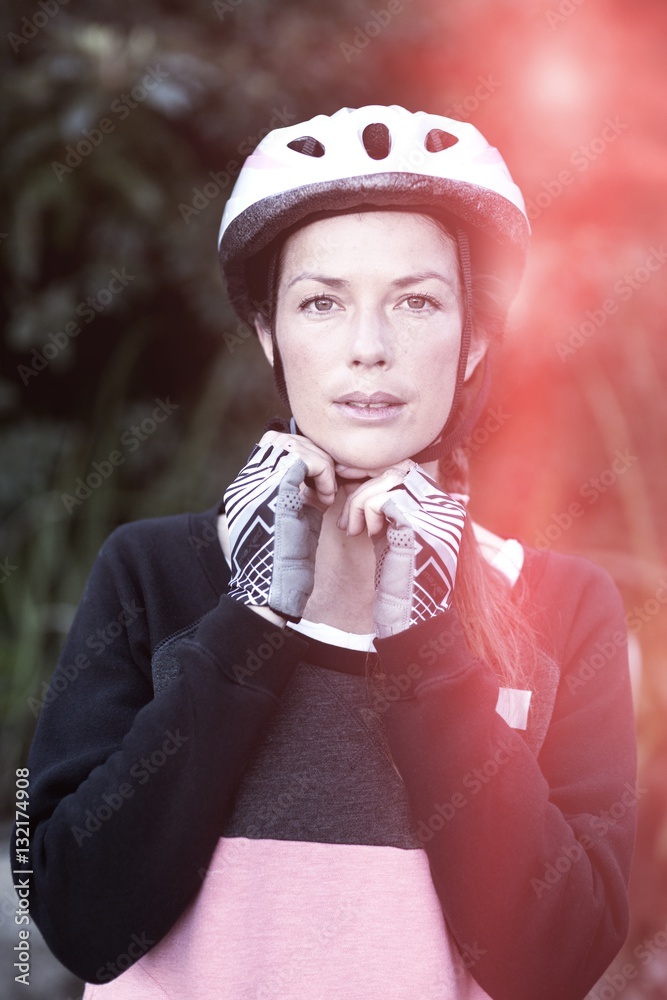 Portrait of female biker wearing bicycle helmet