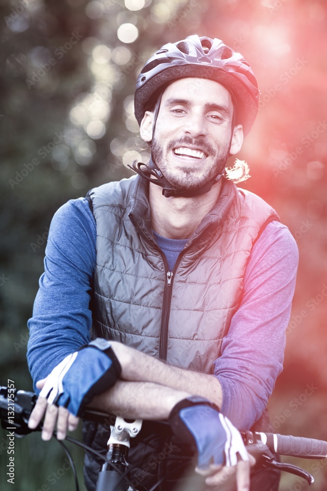 Portrait of male biker with mountain bike