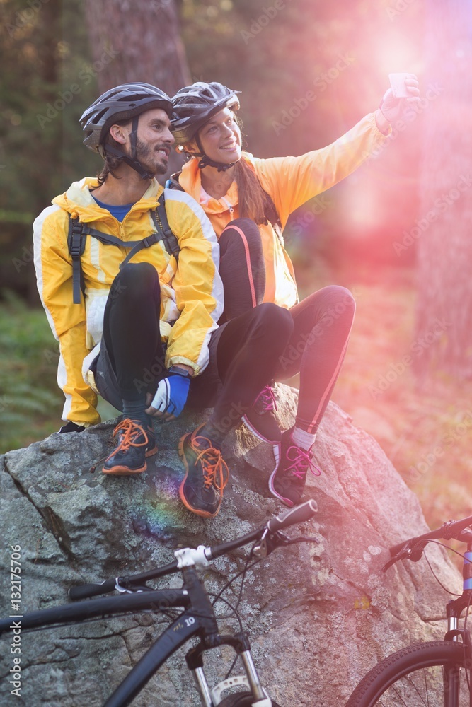 Biker couple taking selfie from mobile phone