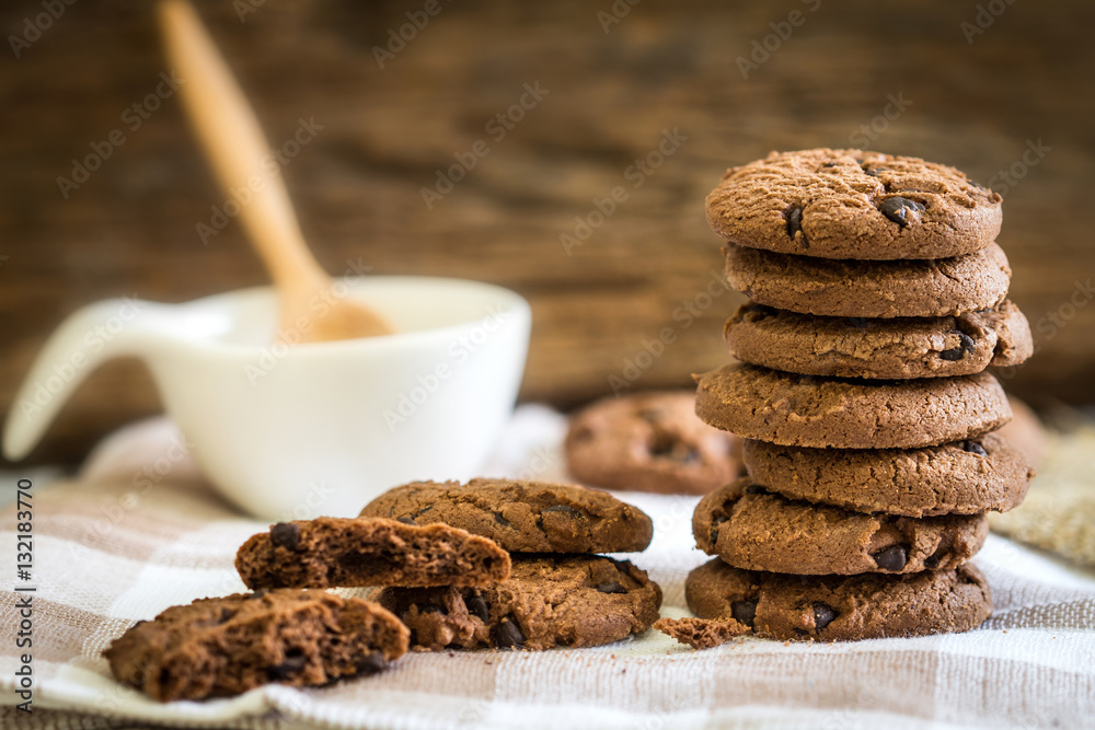 Close up stacked chocolate chip cookies on  napkin 