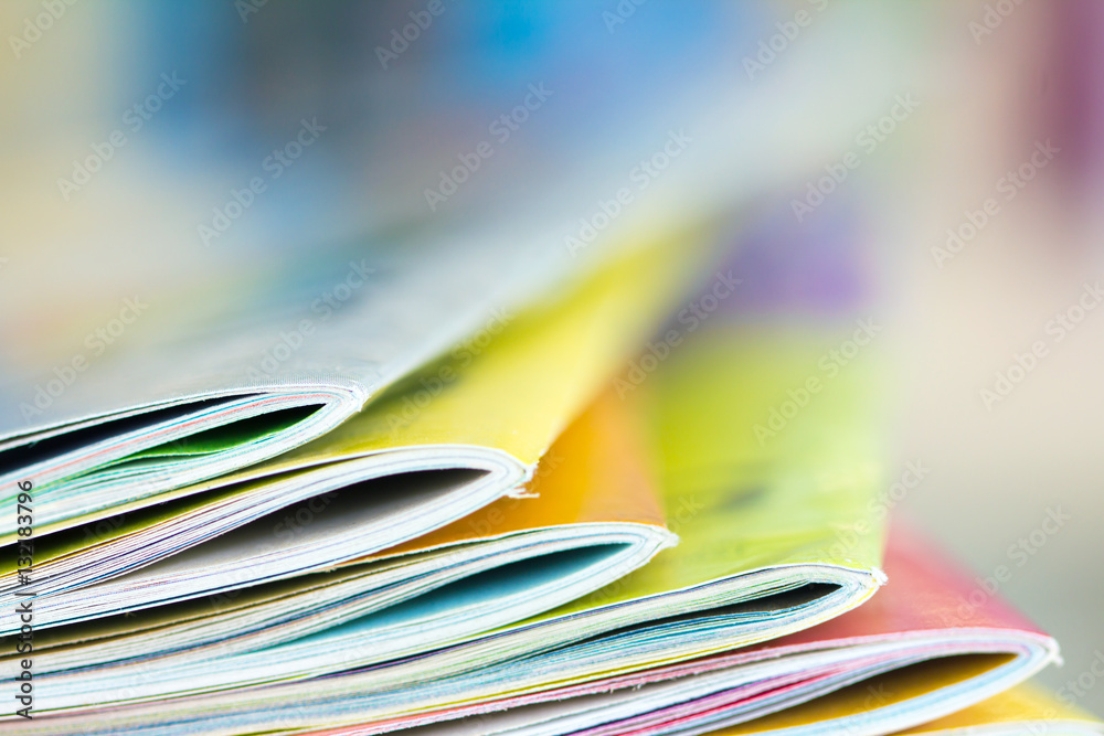 Close up edge of colorful magazine stacking 