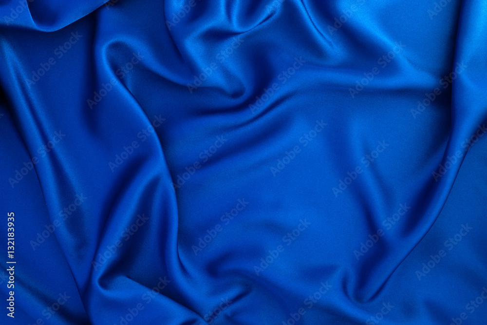 Close up wave blue silk or satin fabric background