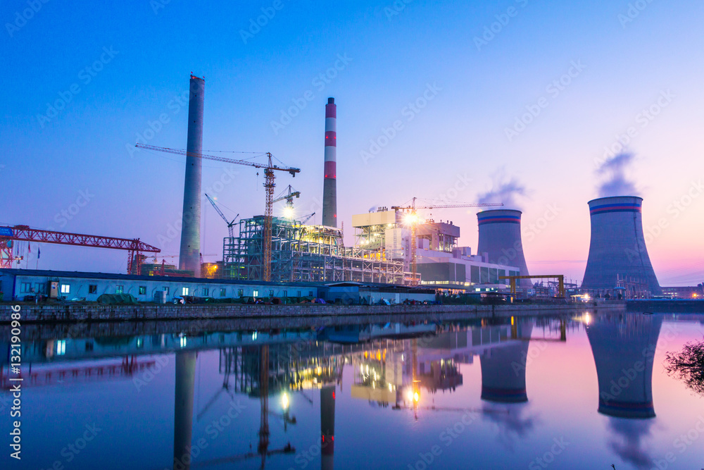 modern waterfront power plant at sunset