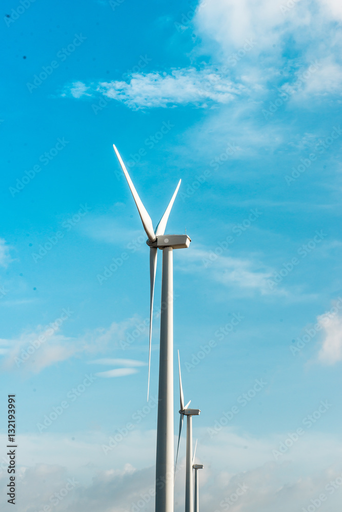 Wind turbines. Ecology wind against cloudy sky background with c