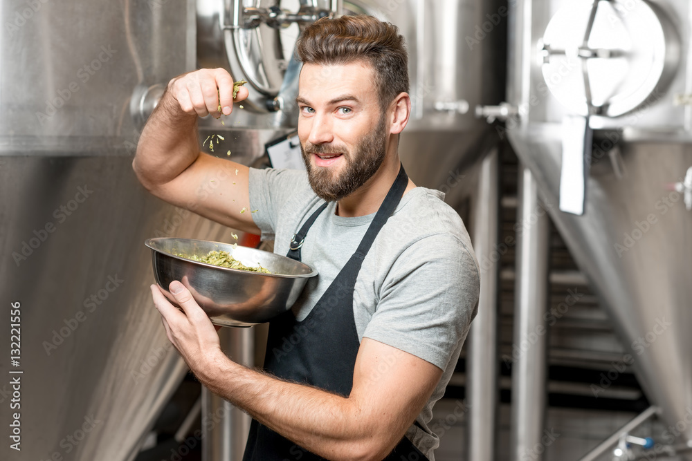 Brewer checking quality of the hop at the manufacturing