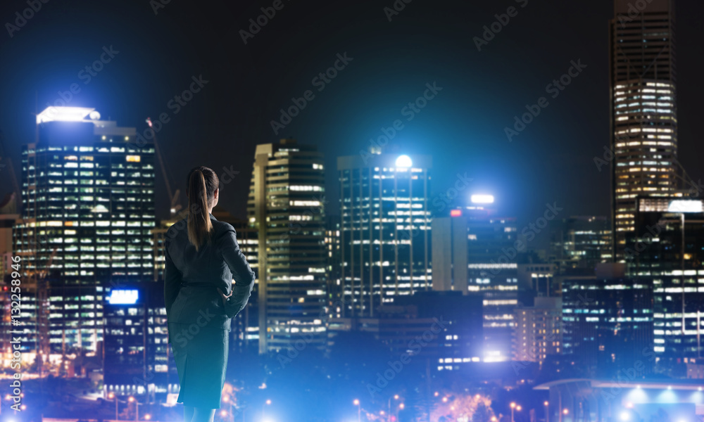 Woman looking at night city