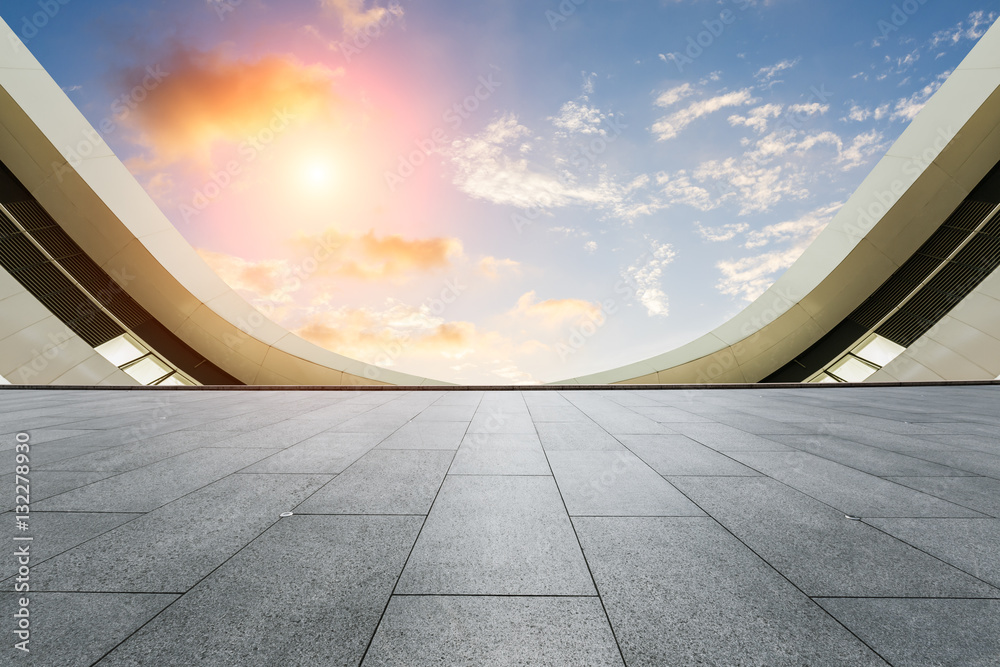 Empty floor and modern architectural passageway at sunset