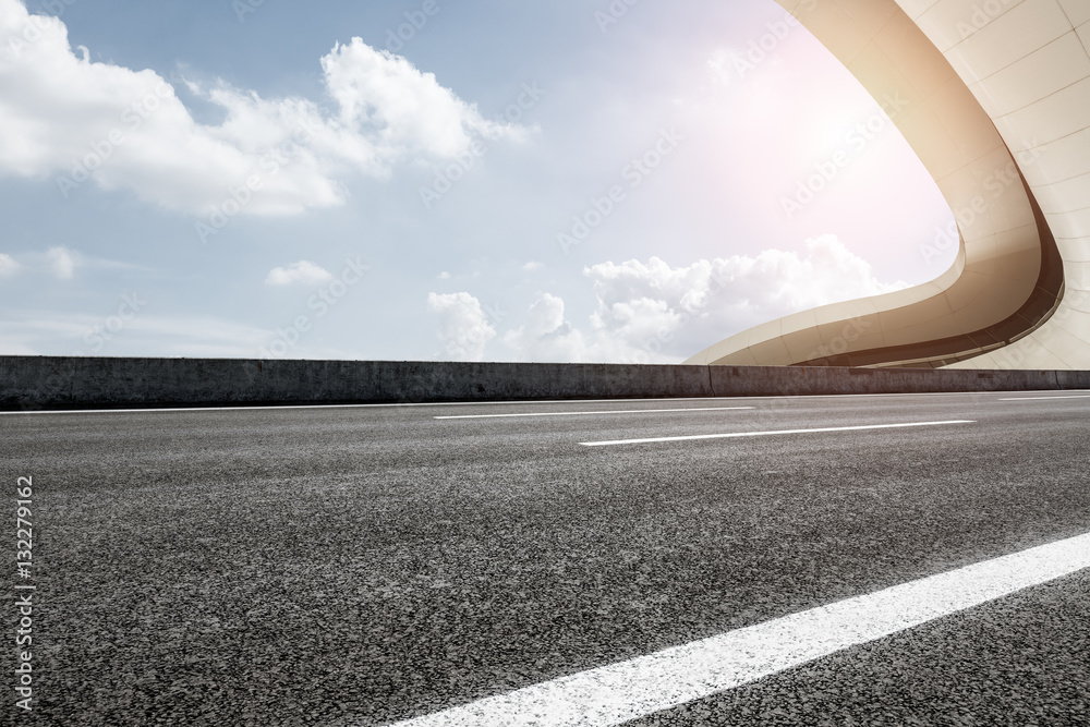 Asphalt road in front of modern bridge construction