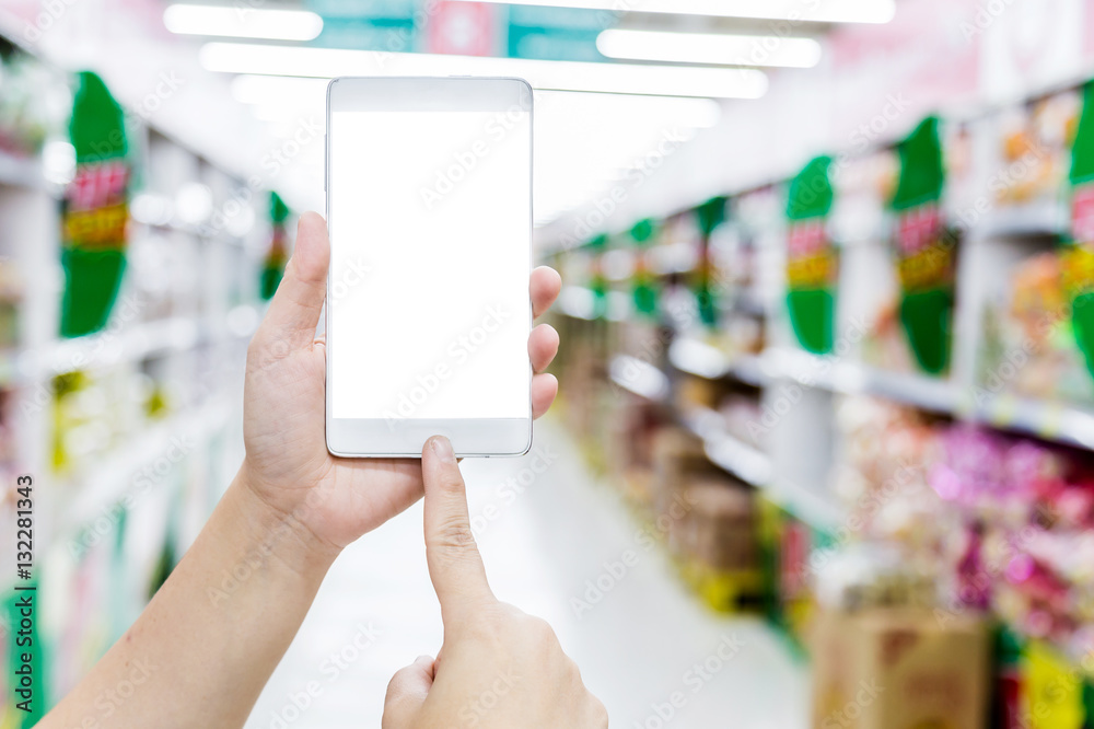 Female hand hold smartphone at supermarket and checking shopping