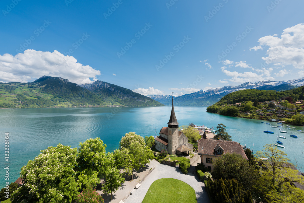 Spiez castle with sailboat on lake Thun in Bern, Switzerland.