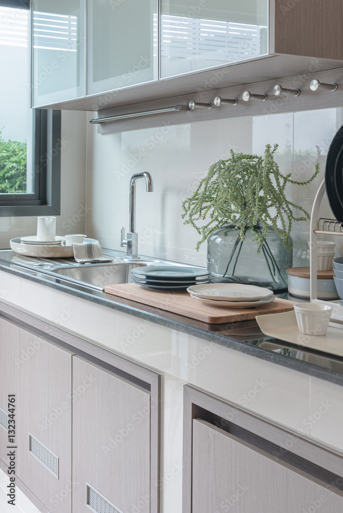 modern kitchen room with sink on top granite counter