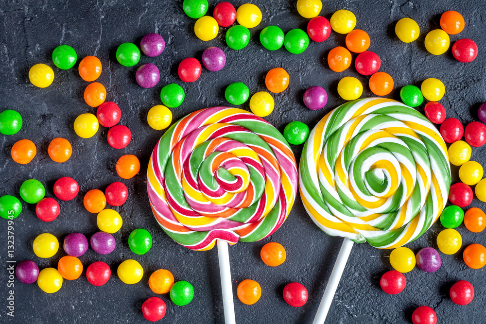 sweets and sugar candies on dark background top view