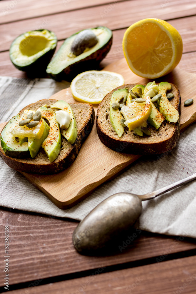 making sandwiches with avocado healthy organic food top view