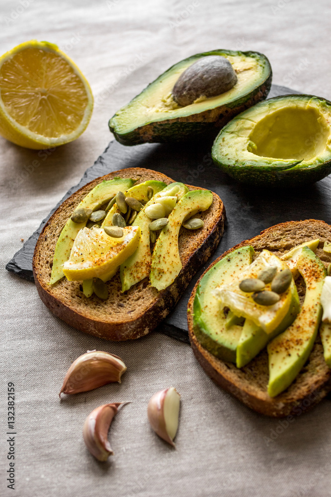 making sandwiches with avocado healthy organic food top view