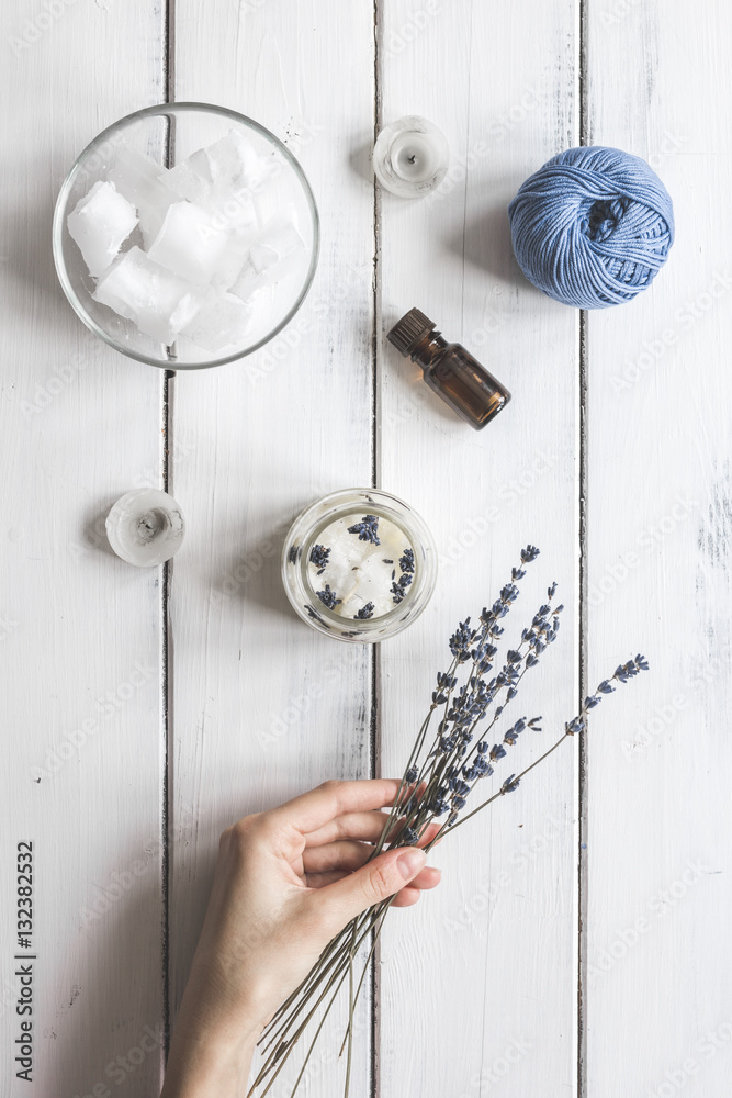 handmade candles with lavender on wooden background top view