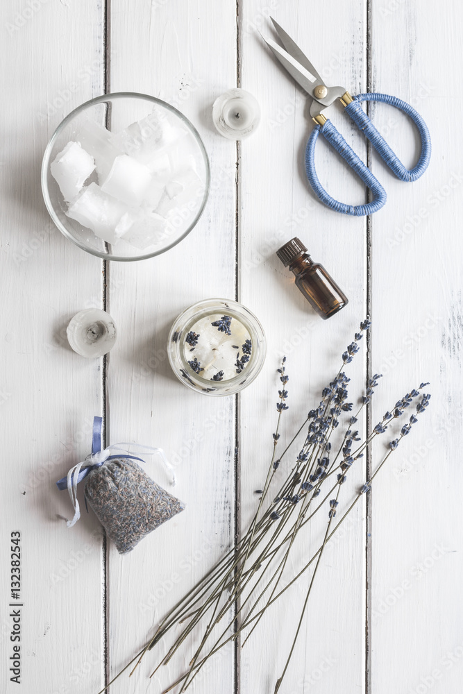 handmade candles with lavender on wooden background top view