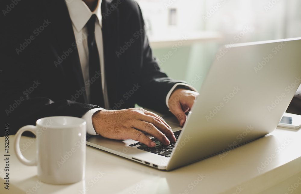 Businessman hands working on laptop,Blurred background .