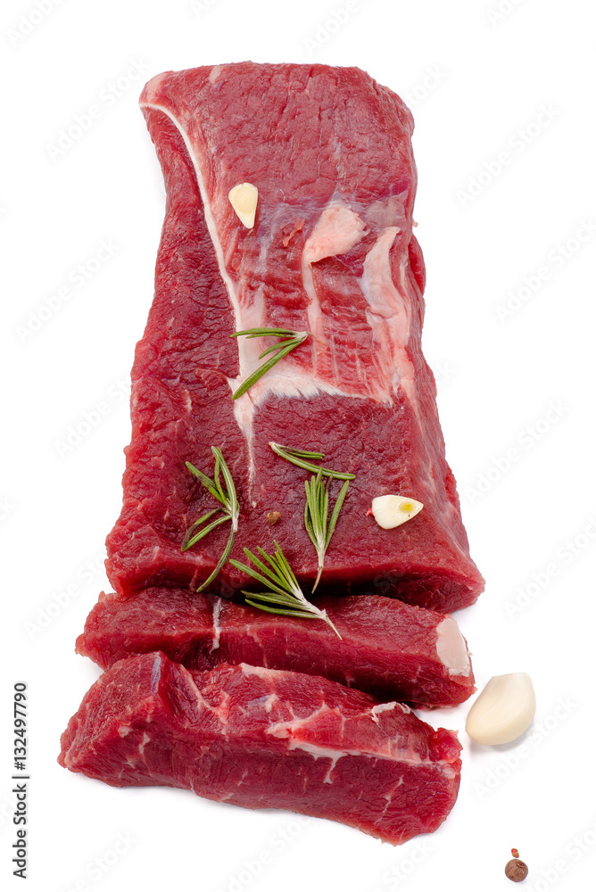 Pieces of meat with garlic and rosemary isolated on white background. Raw beef. Roast. Top view.