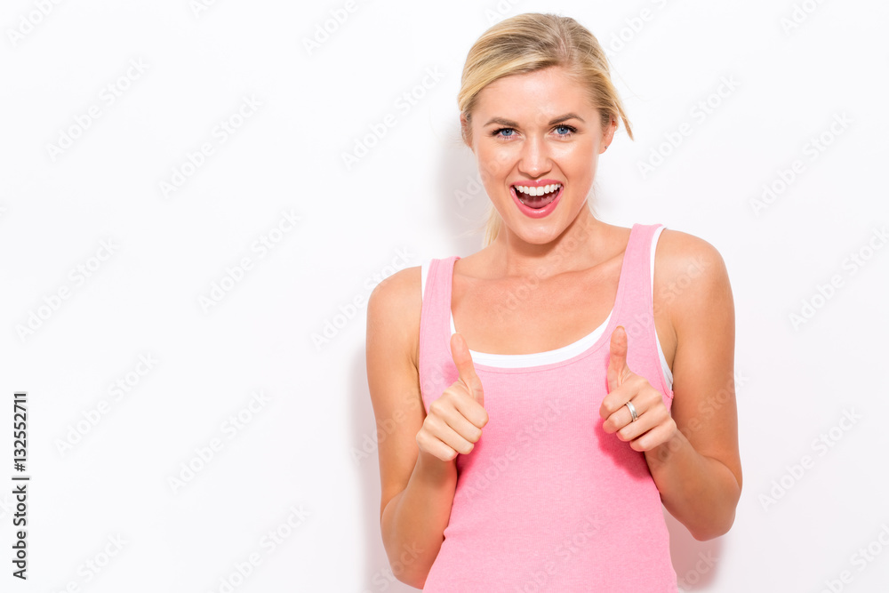 Happy young woman giving thumbs up