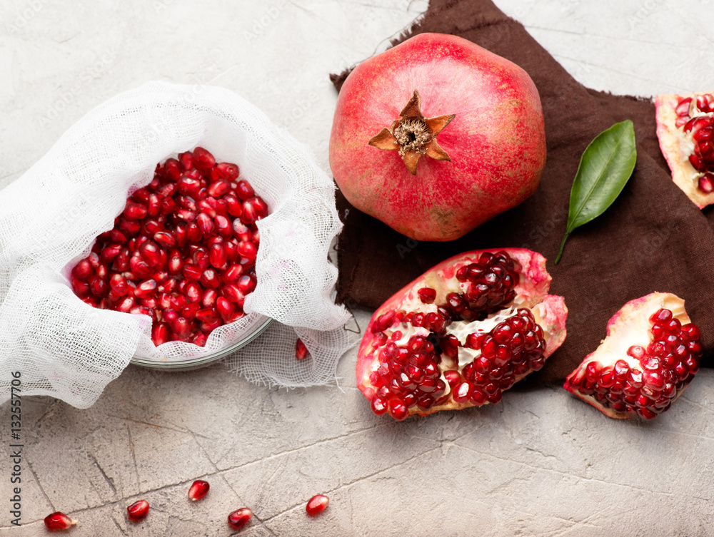 Pomegranate fruits with grains and leaves on the table. Top view. Make juice.