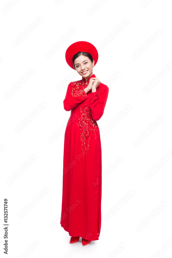 Young vietnamese woman in Ao Dai Dress with praying gesture wishing.