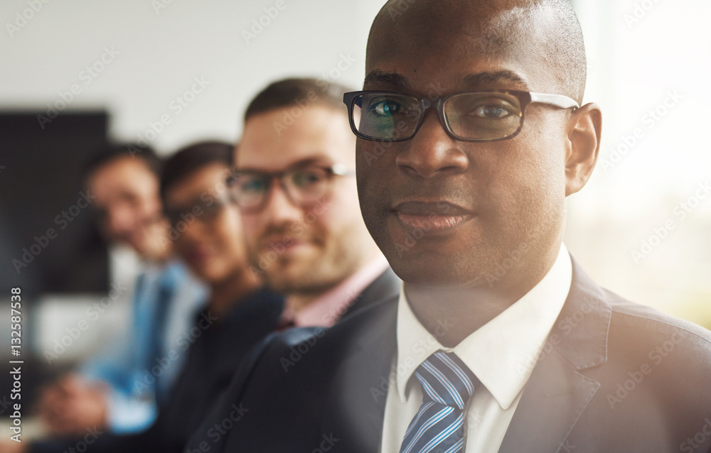 Handsome black business man with three employees