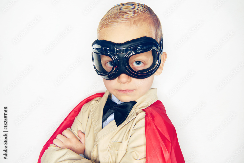 Little kid in aviator glasses and cloak