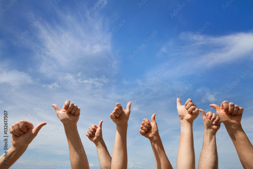 like concept, many hands showing thumb up or ok sign on blue sky background