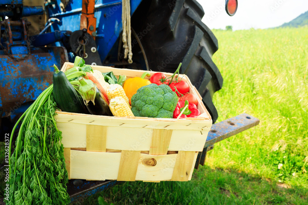 Box With Vegetables Next To A Tractor