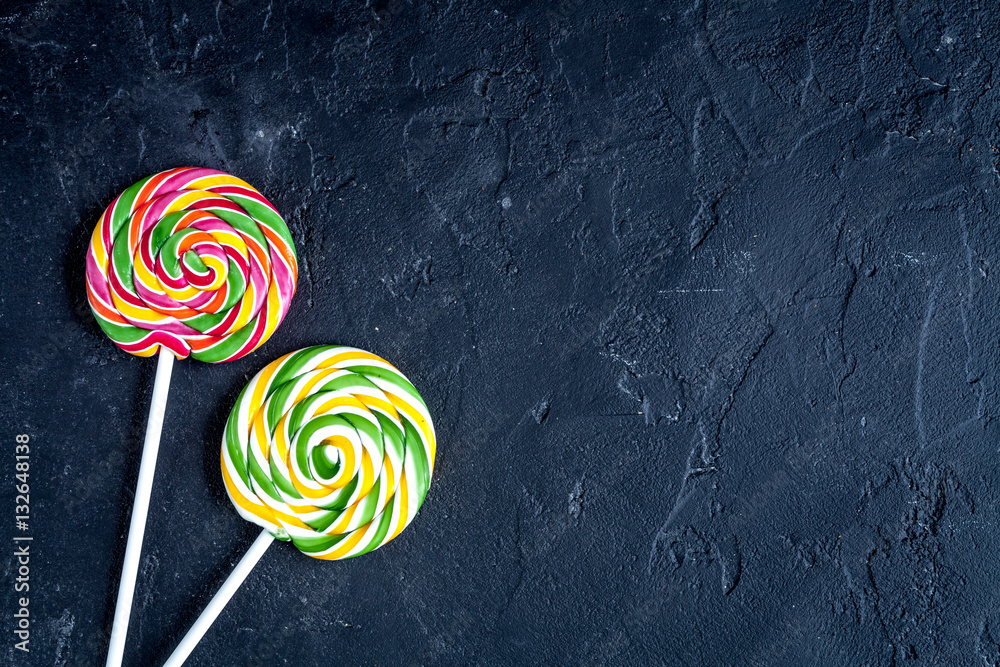 sweets and sugar candies on dark background top view