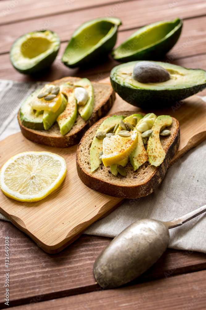 making sandwiches with avocado healthy organic food top view