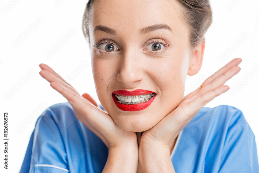 Close up portrait of smiling woman with tooth braces. Studio shot on the white background