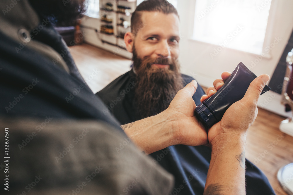 Barber serving client at his shop