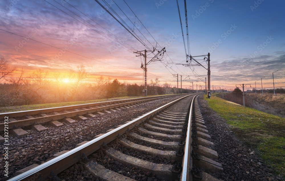 Railway station against beautiful sunny sky. Industrial landscape with railroad, blue sky and colorf